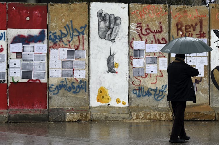 Copies of university degrees stuck on hoardings in Beirut